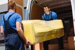 selective-focus-movers-unloading-sofa-stretch-wrap-truck-outdoors_824701-2855-1.webp